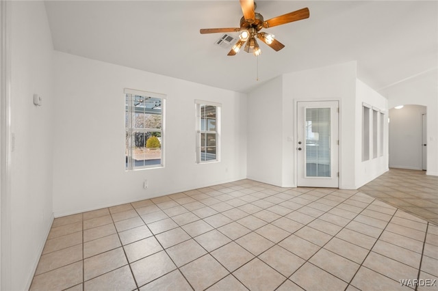 unfurnished room with ceiling fan, visible vents, and arched walkways