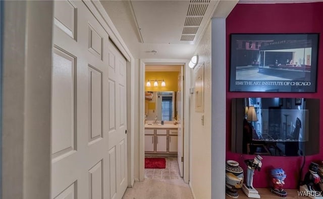 hallway with a sink and visible vents