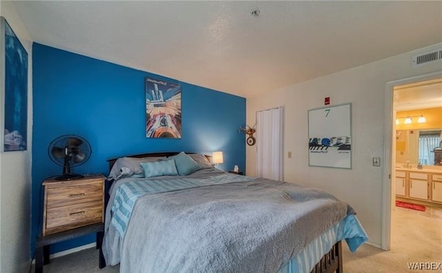 carpeted bedroom featuring visible vents