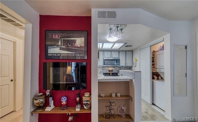 kitchen with visible vents, stainless steel appliances, and light countertops