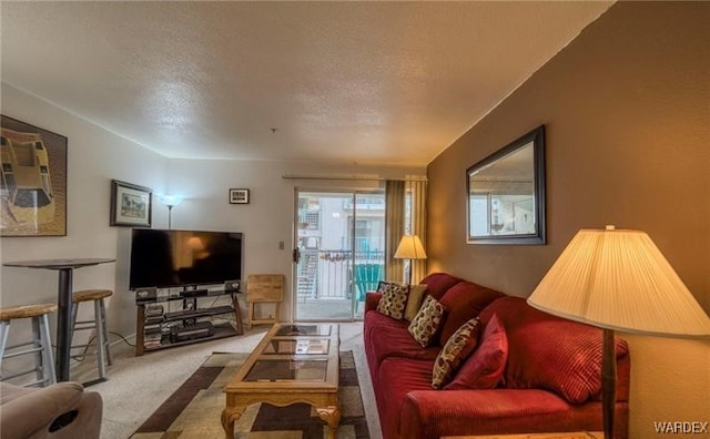 living room featuring carpet floors and a textured ceiling