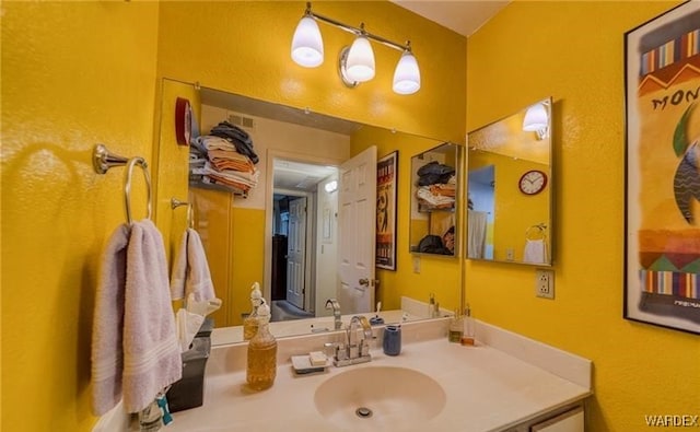 bathroom with visible vents and vanity