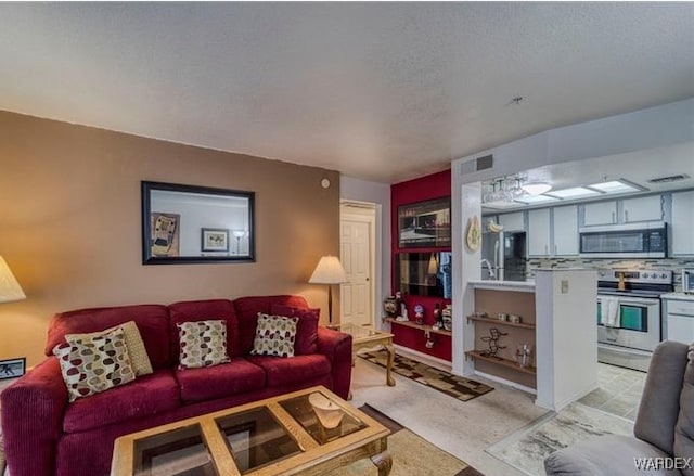 living area featuring a textured ceiling