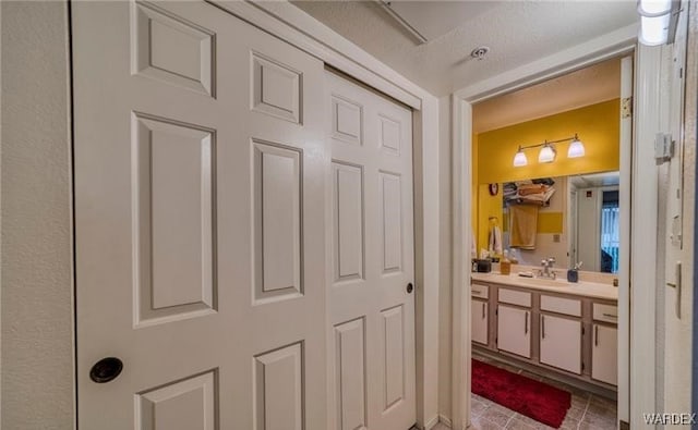 bathroom with tile patterned flooring and vanity