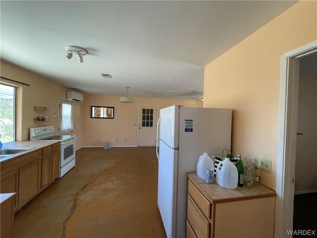 kitchen with tile countertops, white appliances, a sink, a wall mounted AC, and unfinished concrete floors