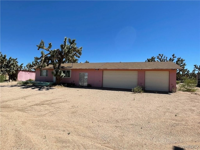 ranch-style house featuring driveway and an attached garage