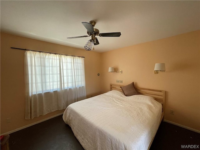 bedroom featuring ceiling fan and baseboards