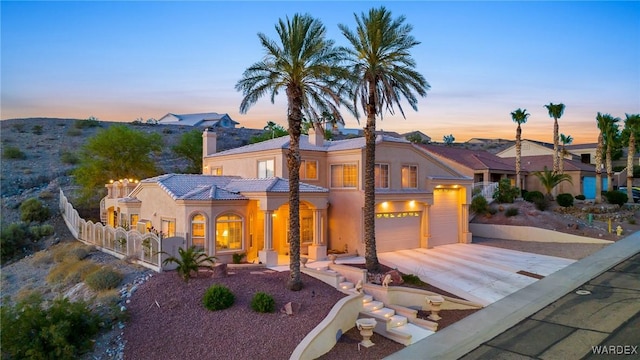 view of front of property with fence, driveway, a residential view, stucco siding, and a chimney