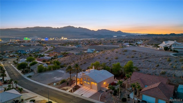 aerial view at dusk featuring a residential view and a mountain view