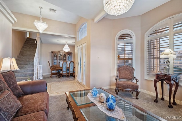 living room featuring a notable chandelier, light carpet, visible vents, baseboards, and stairway