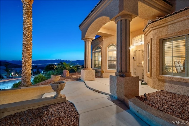 patio terrace at dusk with a mountain view