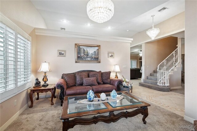 living area with light colored carpet, visible vents, baseboards, and stairs