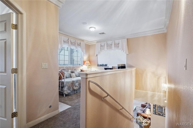 interior space with ornamental molding, visible vents, and baseboards