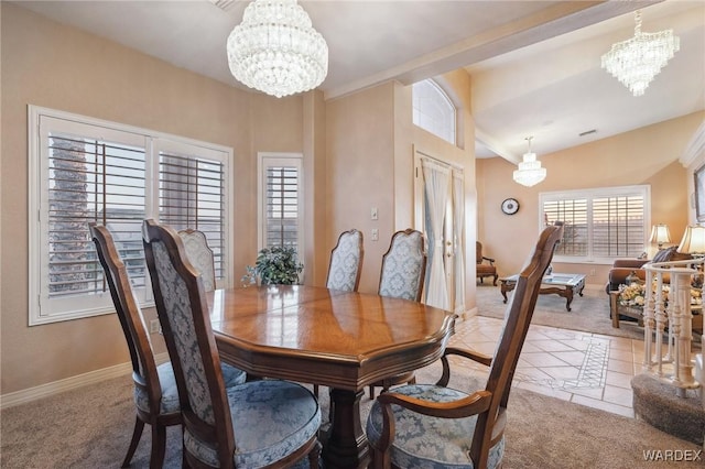 carpeted dining space featuring tile patterned flooring, visible vents, baseboards, and a notable chandelier