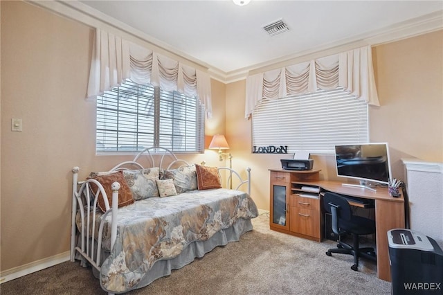 bedroom with visible vents, crown molding, and light carpet