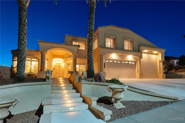 view of front of house with concrete driveway and stucco siding