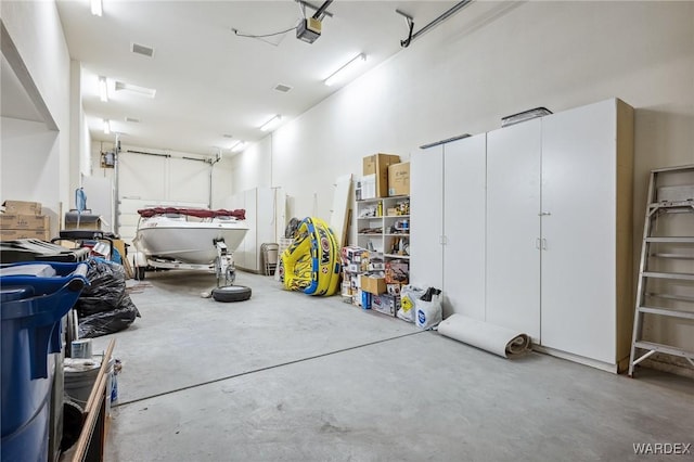 garage with a garage door opener and visible vents