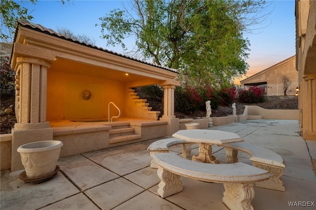 view of patio terrace at dusk