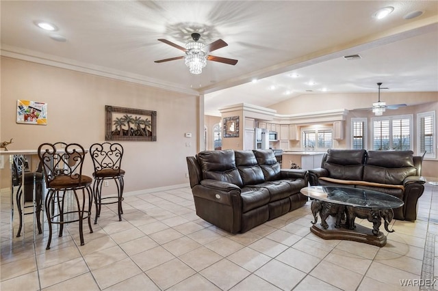 living area featuring lofted ceiling, visible vents, baseboards, and light tile patterned flooring