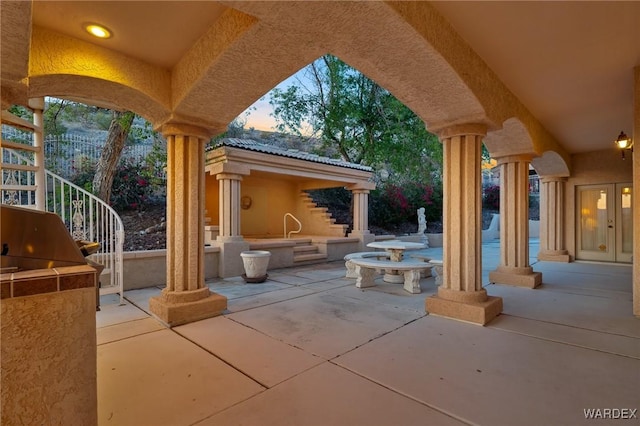 patio terrace at dusk with an outdoor kitchen