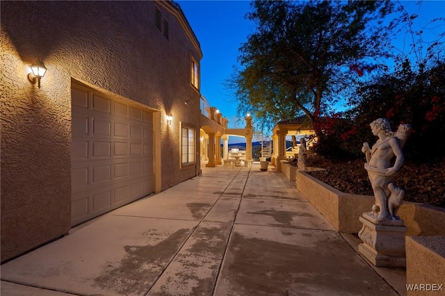 view of property exterior featuring a garage and stucco siding