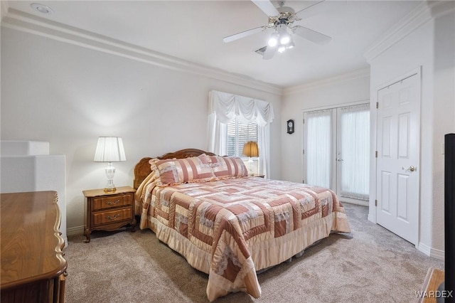 bedroom with light carpet, ceiling fan, baseboards, and crown molding