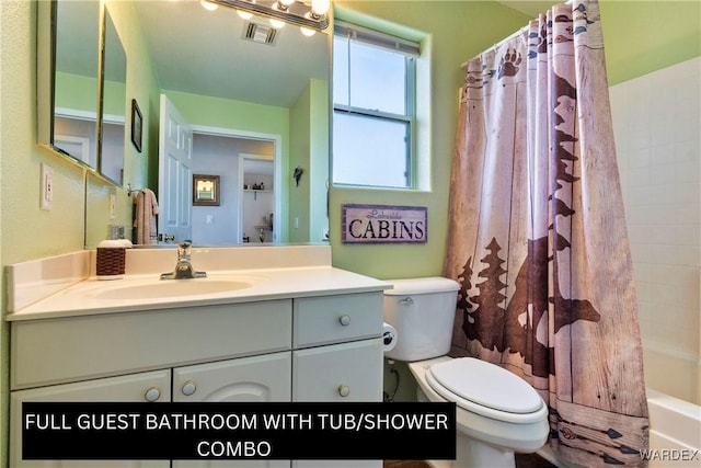 bathroom featuring visible vents, shower / tub combo with curtain, vanity, and toilet