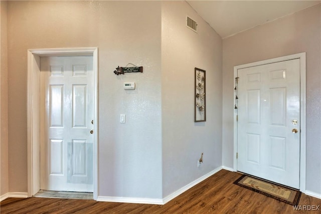 entryway with dark wood-style floors, visible vents, and baseboards