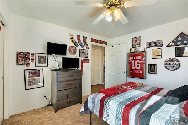 bedroom with light carpet, ceiling fan, and baseboards