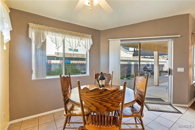 dining space featuring ceiling fan, plenty of natural light, baseboards, and light tile patterned floors