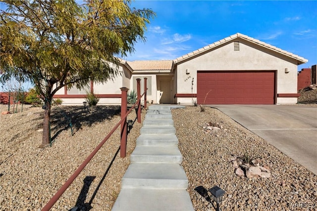 ranch-style house featuring a garage, a tile roof, concrete driveway, and stucco siding