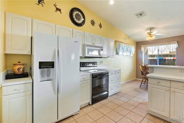 kitchen with white appliances, light countertops, visible vents, and white cabinetry