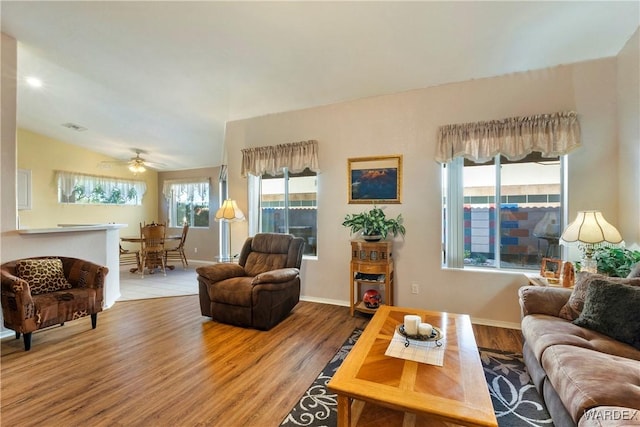 living room featuring visible vents, wood finished floors, and a wealth of natural light