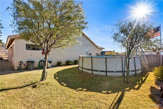 view of yard with fence and a fenced in pool