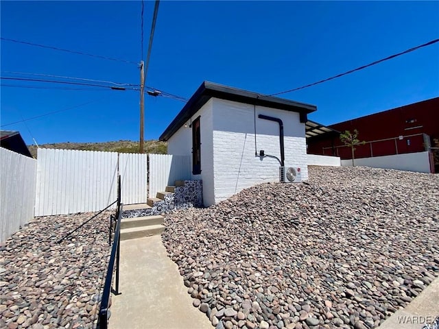 view of home's exterior with fence