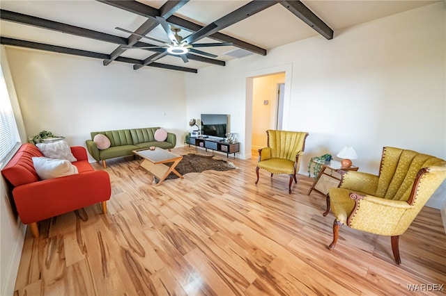 living area featuring light wood finished floors, ceiling fan, coffered ceiling, and beamed ceiling