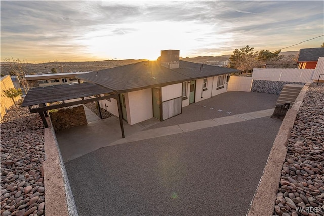 view of front of home featuring a patio area and fence