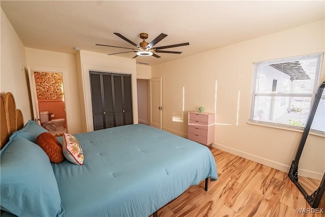 bedroom featuring ceiling fan, a closet, light wood-style flooring, and baseboards