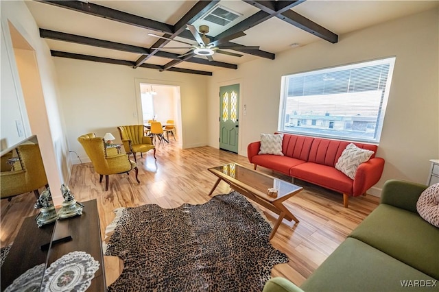 living room with baseboards, visible vents, coffered ceiling, beamed ceiling, and light wood-type flooring