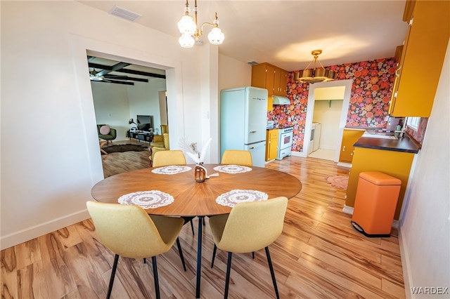 dining room with beam ceiling, visible vents, light wood-style floors, coffered ceiling, and baseboards