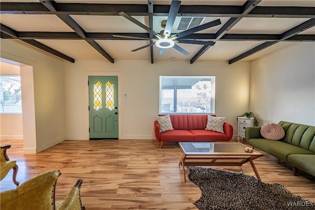 living room featuring ceiling fan, light wood finished floors, beam ceiling, and baseboards