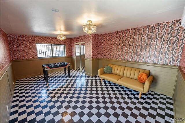 playroom featuring a wainscoted wall, a notable chandelier, and wallpapered walls