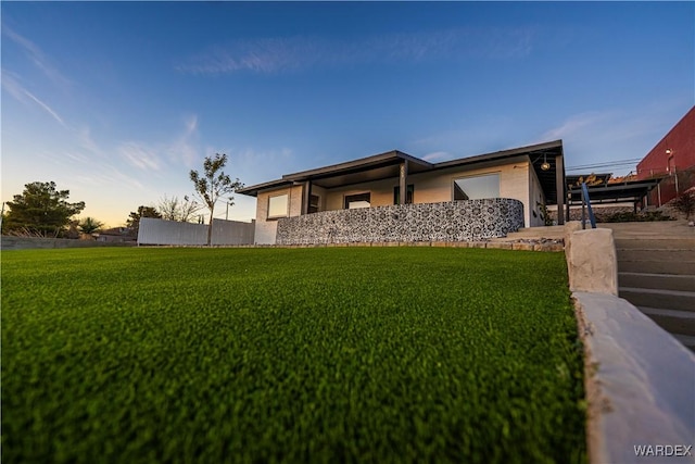 view of front of property with a front lawn and fence