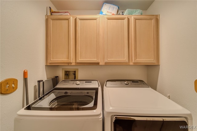 laundry area with cabinet space and washing machine and dryer