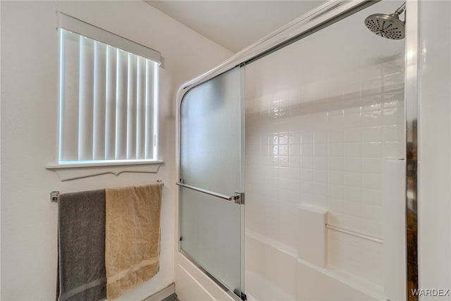bathroom featuring a shower with shower door