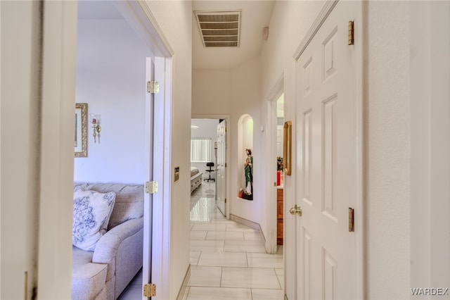 hallway featuring marble finish floor and visible vents
