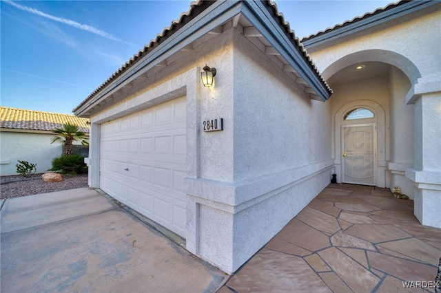 garage featuring concrete driveway