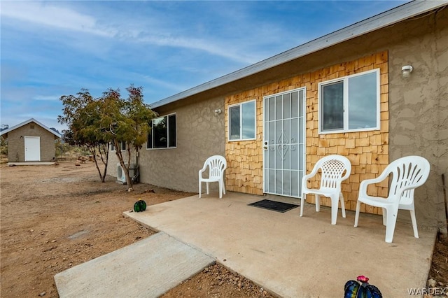 exterior space featuring a patio area and stucco siding