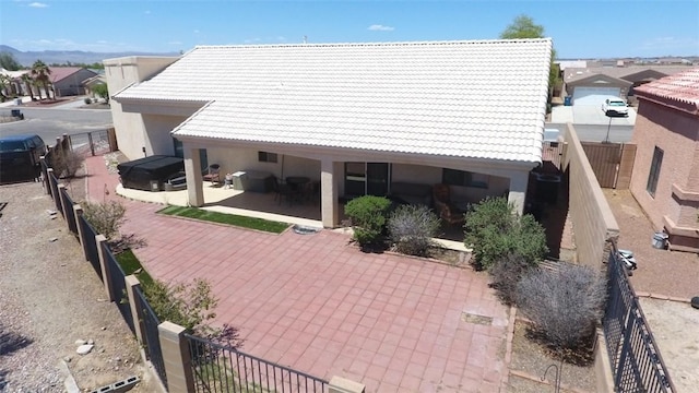 2084 E Crystal Dr, Fort Mohave, AZ 86426 - back of house featuring a tiled roof, a patio, stucco siding, a fenced backyard, and a hot tub