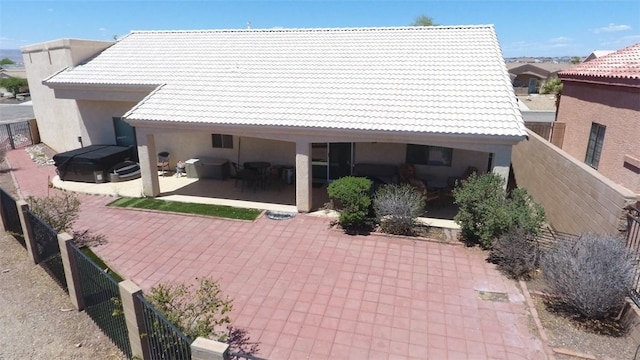 2084 E Crystal Dr, Fort Mohave, AZ 86426 - rear view of property with a hot tub, a patio area, a tile roof, and stucco siding